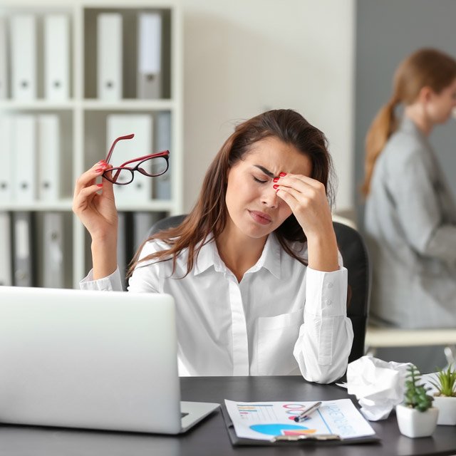 Stressed businesswoman at laptop