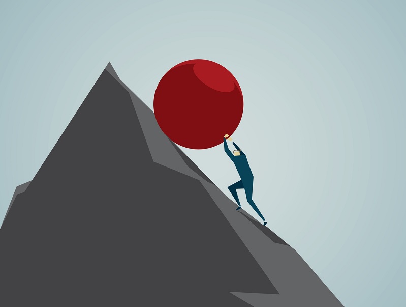 Man rolling red ball up a mountain. Conquering adversity.