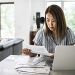 Woman paying bills at home