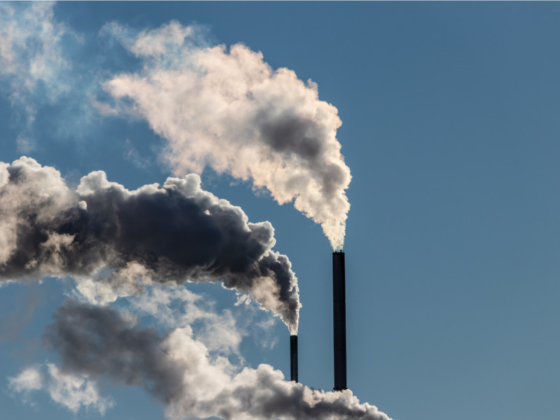 Smoke stacks from a factory releasing emissions