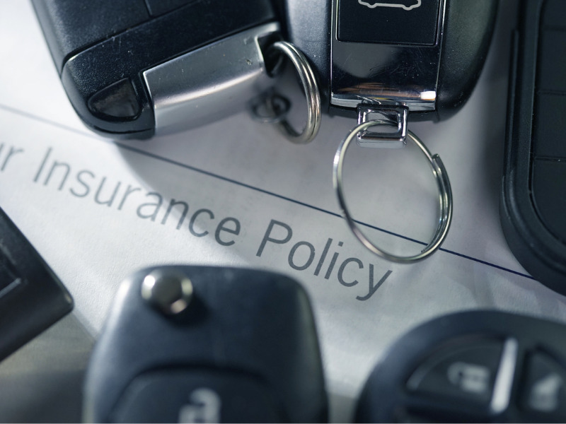 Auto insurance policy with keychain on top
