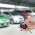 Person looking for car at rental lot - how to get a cheap long term car rental