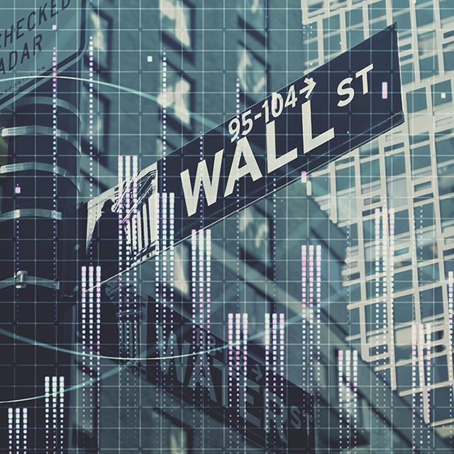 stock image of wall street sign and buildings in background