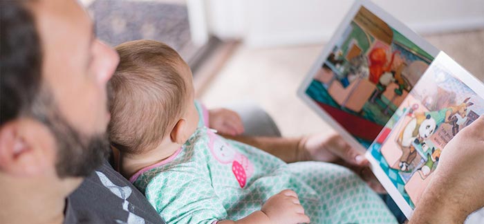 Image of father reading a story to baby girl for Quotacy blog: How Long Should My Life Insurance Last.