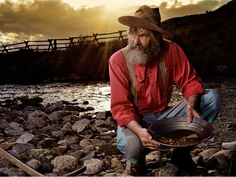 Prospector panning for gold in the old west.