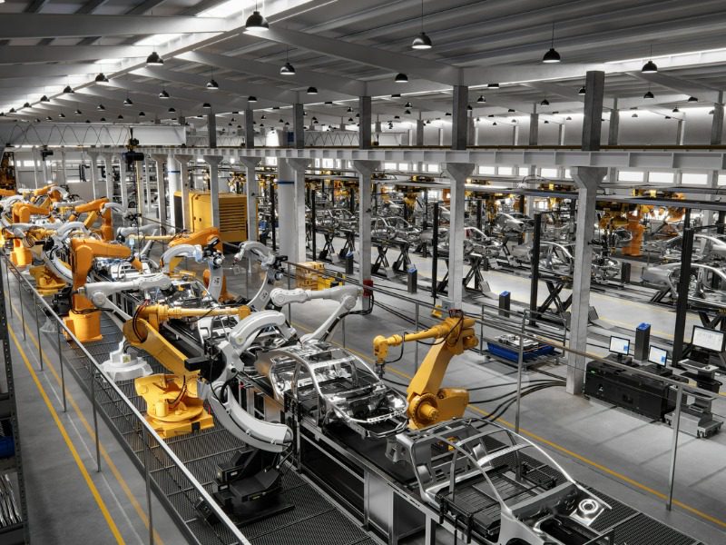 Cars on a robotic assembly line in a commercial facility.