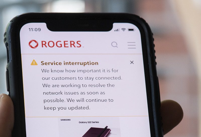 A cell phone displaying a Rogers service interruption alert