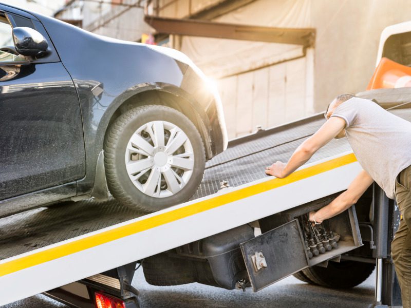 Car loaded on a tow truck for delivery