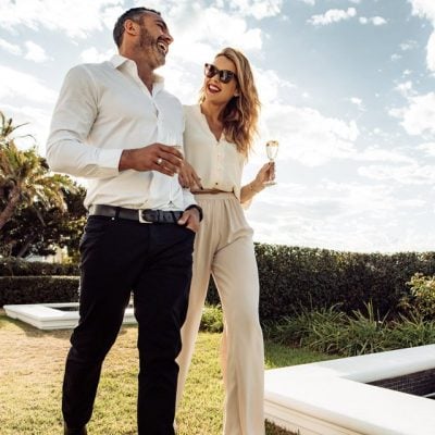 Adobe stock image of young wealthy couple walking in a park