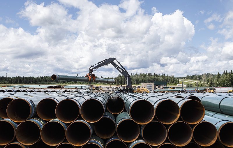 Pipe for the Trans Mountain pipeline is unloaded in Edson, Alta. on Tuesday June 18, 2019. A coalition of 32 environmental and Indigenous groups is calling on 27 insurance companies to drop or refuse to provide coverage of the Trans Mountain pipeline, although they concede its lead liability insurer is planning to continue coverage. THE CANADIAN PRESS/Jason Franson