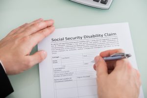stockfresh_6779024_person-hand-over-social-security-disability-claim-form_sizeS-300x200