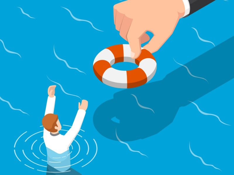 Big hand giving a drowning business person a life preserver