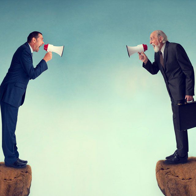 Two people shouting at each other through megaphones