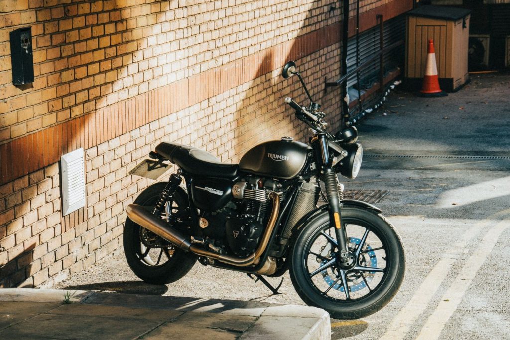 Triumph Street Twin parked in front of brick wall