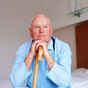 older man leaning on a cane from Shutterstock