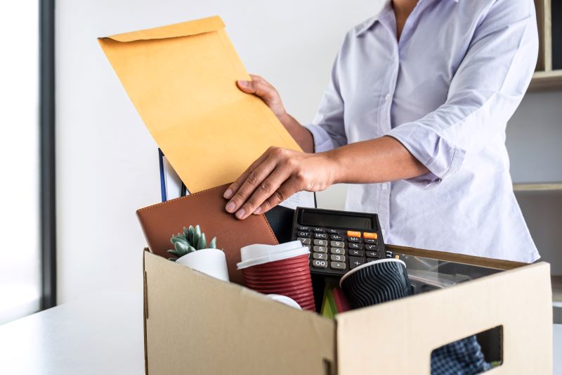 Woman packing her office belongings in a box