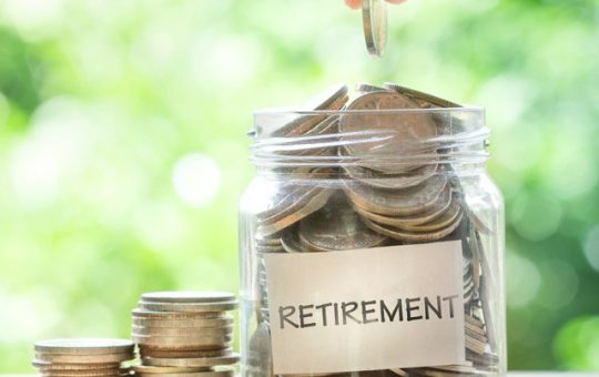 Retirement savings coins in a jar