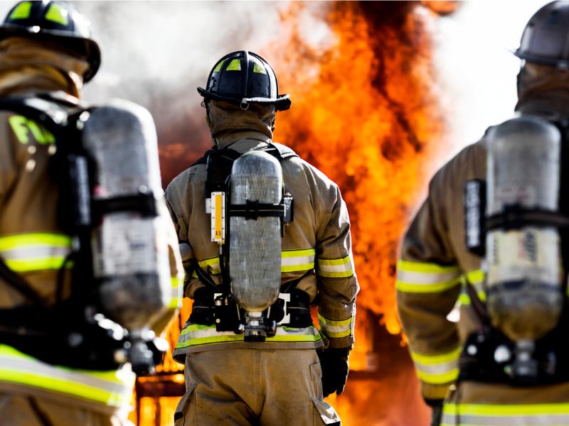 Three firefighters battling a house blaze