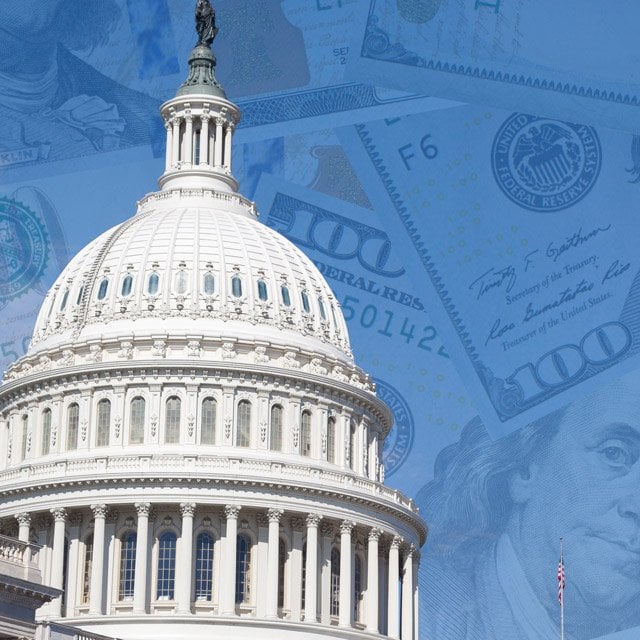 A picture of the U.S. Capitol dome, in front of floating money