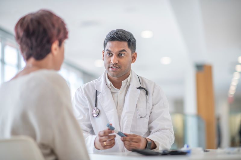 Doctor talking to a patient in a hospital hallway