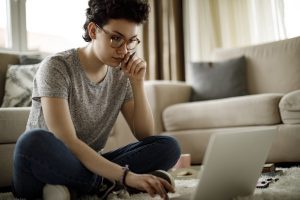 Young woman in living room on laptop