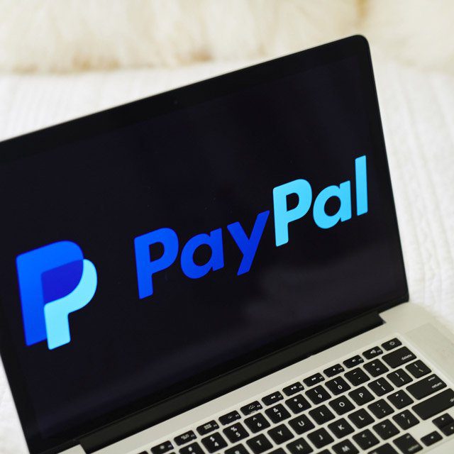 Laptop showing the PayPal logo
