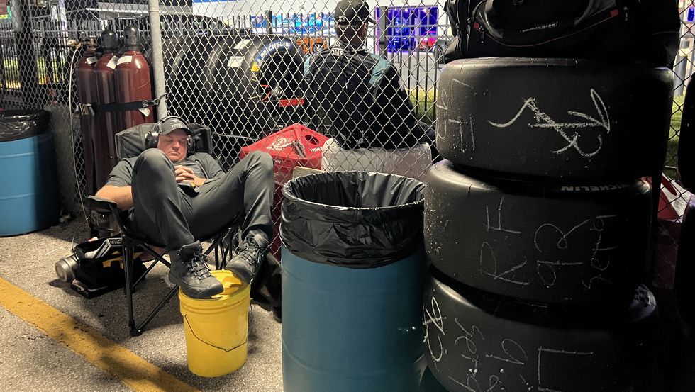 A team member sleeping at the 24 Hours of Daytona a team member sleeping at the 24 hours of daytona