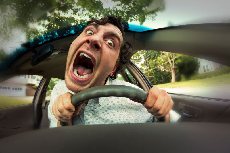 Distorted image of the head of a road rager driving a car