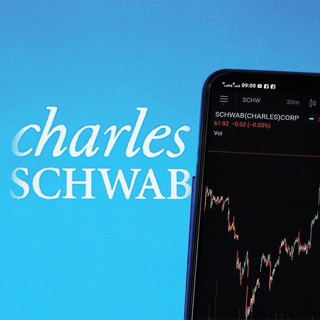 Charles Schwab logo with phone and stock chart