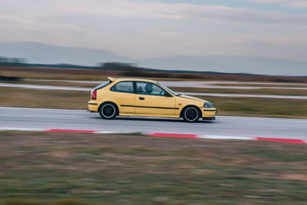 Yellow Honda Civic EK9 on race track