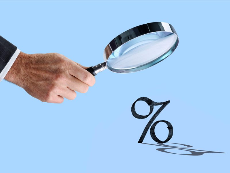 Magnifying glass looking at interest rates