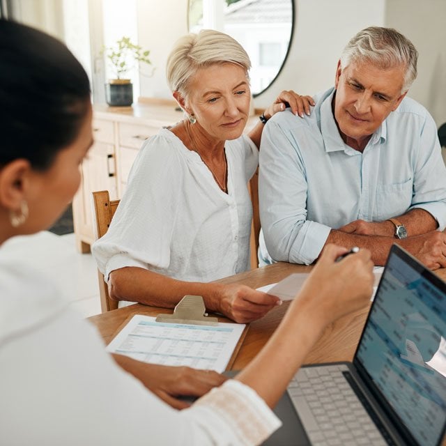 Advisor talking to older client couple