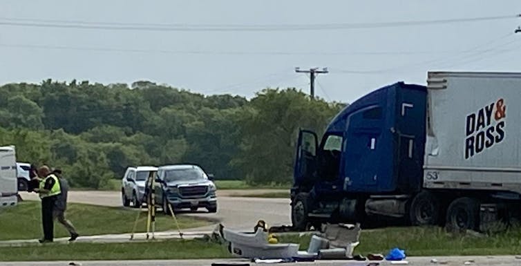 A damaged semi-truck on a road.