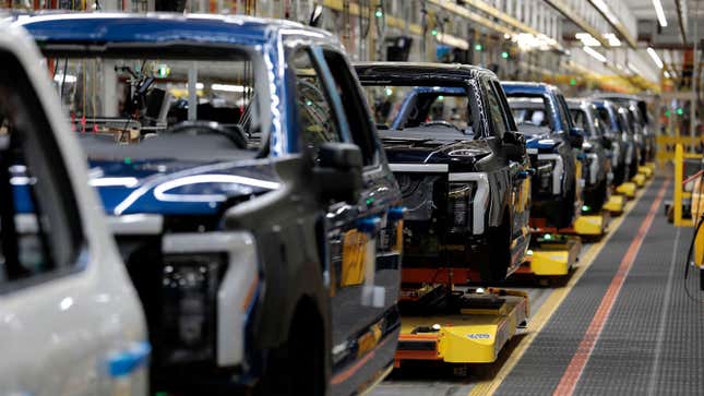 A photo of Ford F-150 Lightning trucks on the production line. 