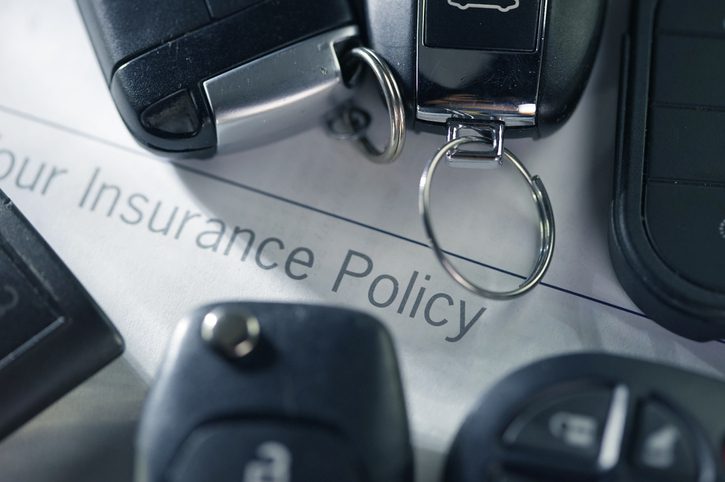 cay keys on top of an auto insurance policy