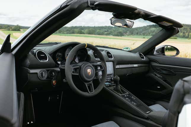 The black interior of the Porsche 718 Spyder RS with the top down.