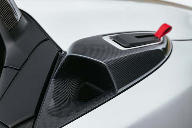 The carbon fiber open air intake behind the driver's head on a 2024 Porsche 718 Spyder RS