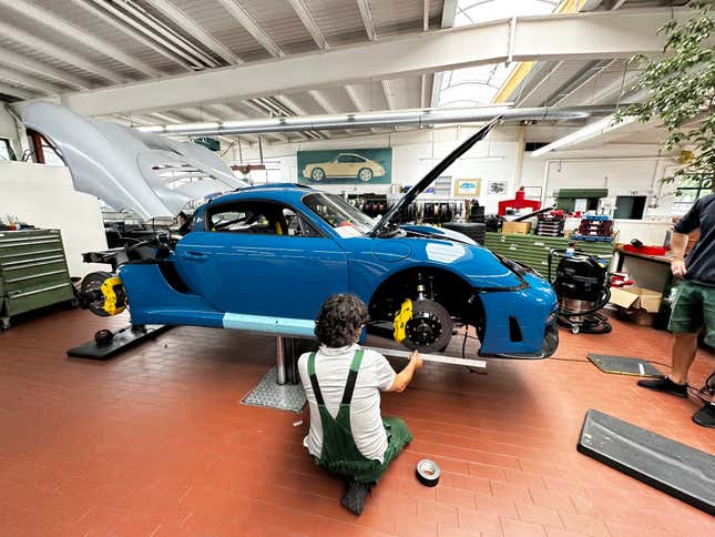 A Ruf technician works on a bright blue CTR3 