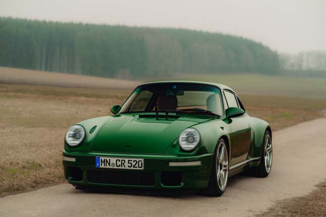 A dark green Ruf SCR is parked on a dirt road