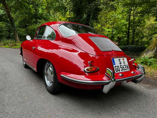 A red 1963 Porsche 356 Super 90 Coupe is parked in the Black Forest, rear three-quarter view