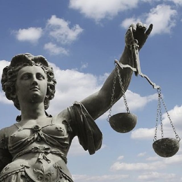 A statue of a goddess holding up the scales of justice