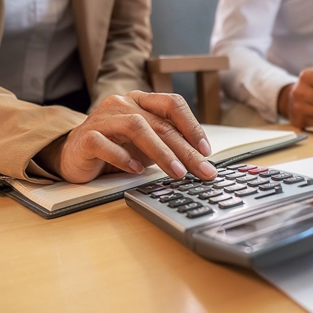 A man using a calculator