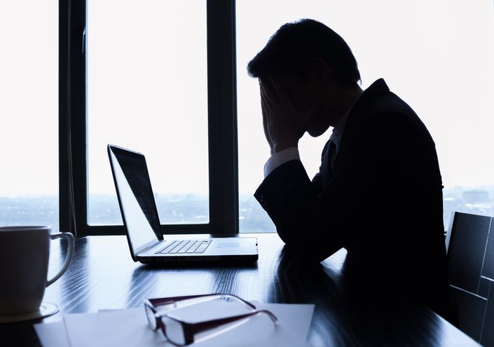 Silhouette of stressed business man in the office