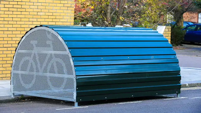 A photo of a secure bike store on a street in London. 