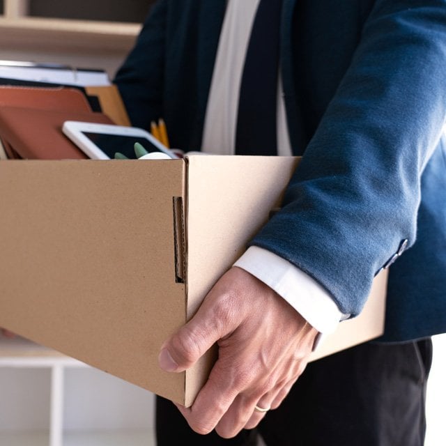 Businessman carrying his stuff in a box