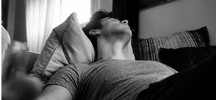 Image of young man taking a nap for Quotacy blog How Does Sleep Apnea Affect Life Insurance Rates?
