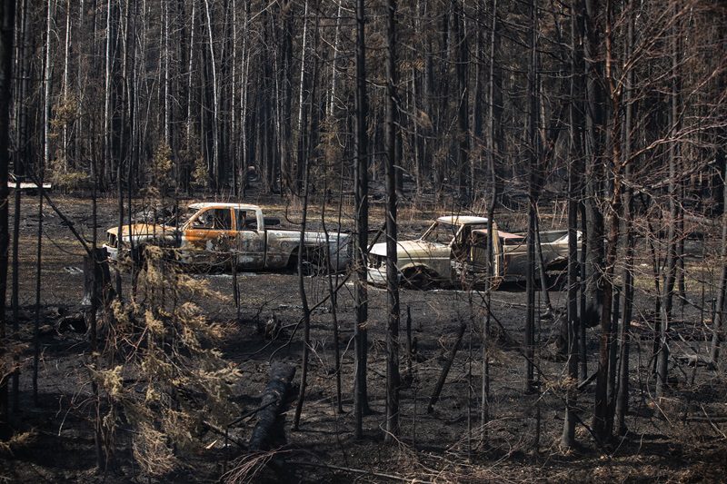 Burnt out trucks from a wildfire in Drayton Valley, Alta. in May 2023