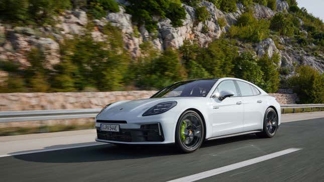 A white Porsche Panamera 4S E-Hybrid driving in front of a mountain
