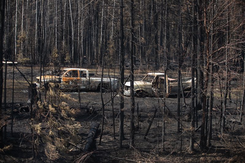 Burnt out trucks from a wildfire in Drayton Valley, Alta. in May 2023
