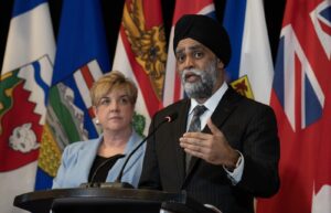 Manitoba Transport Minister Lisa Naylor listens as Minister of Emergency Preparedness Harjit Sajjan responds to a question during a news conference following meetings with provincial partners, Wednesday, February 21, 2024 in Ottawa. THE CANADIAN PRESS/Adrian Wyld